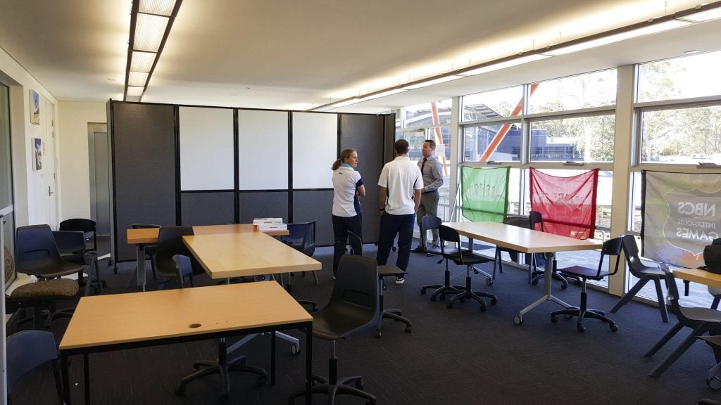 Mobile Whiteboard integrated into a folding classroom divider on wheels.