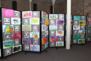 Portable Room Divider 360 in Charcoal Fabric used for school artwork in classroom