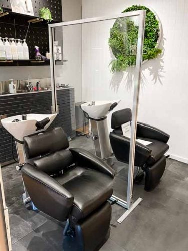 Silver frame floorstanding perspex protection screen at hair salon in sydney nsw Silver frame floorstanding perspex protection screen at hair salon in sydney nsw