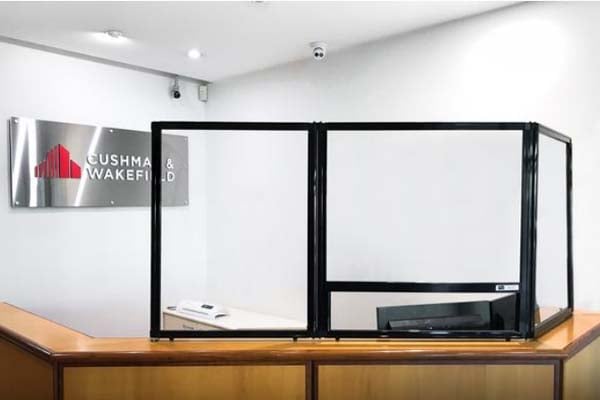 Reception sneeze guard for safer customer service interactions at Cushman & Wakefield office